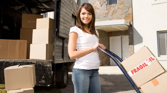 Girl with white tops putting boxes to the customers house